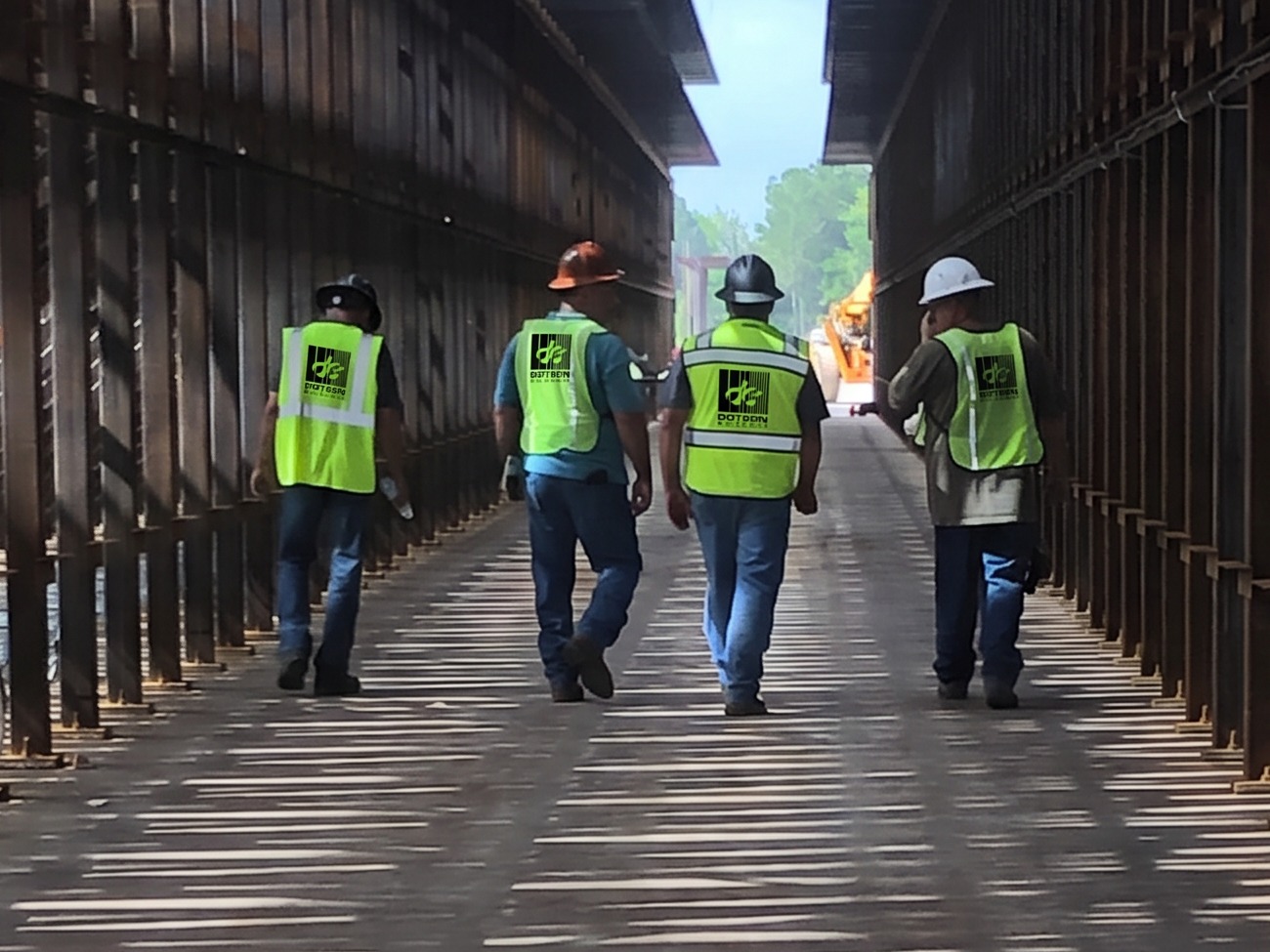 Dotson Electric crew walking a job site in safety vests and hard hats