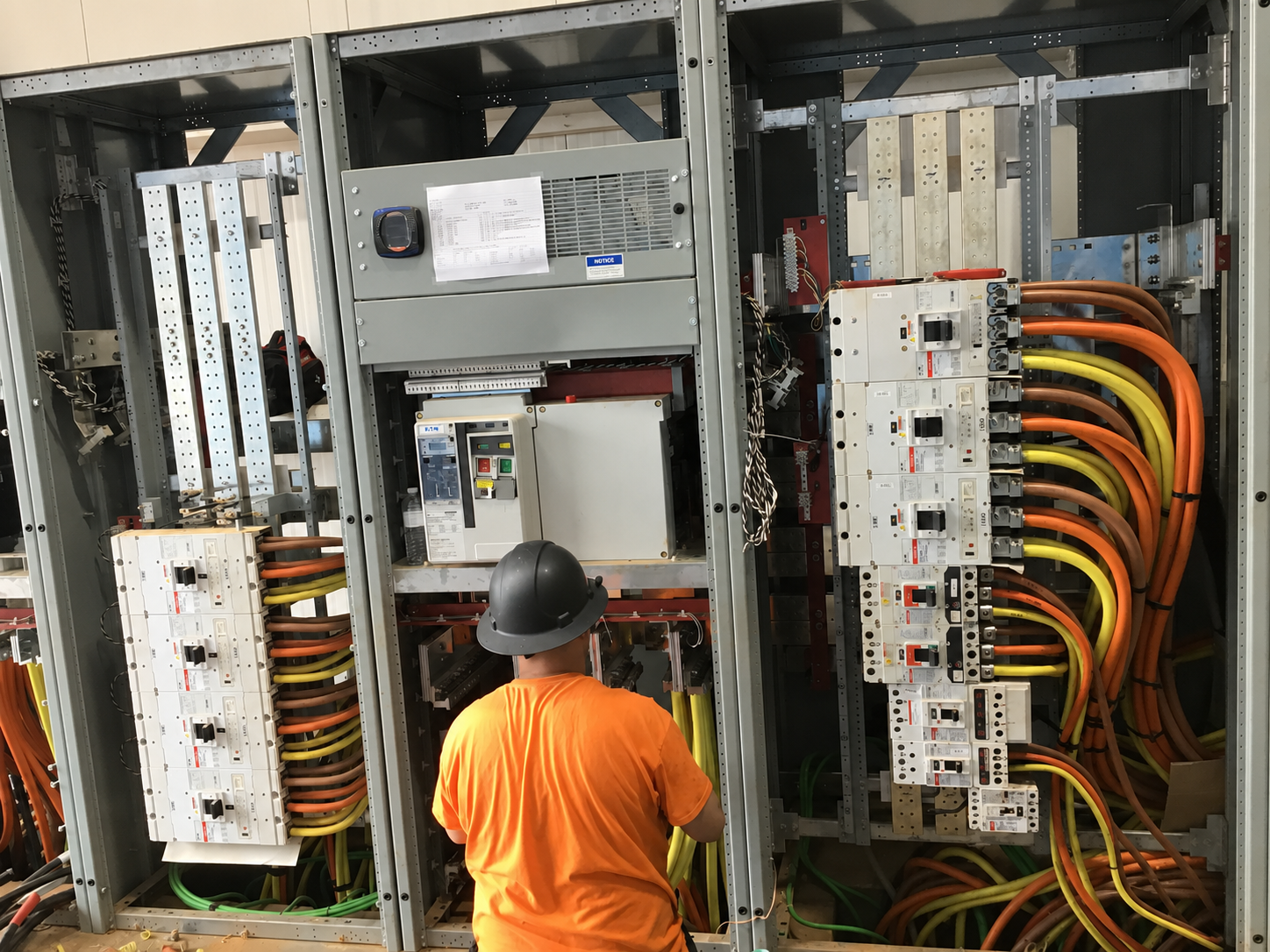 Electrician terminating feeders in switchgear