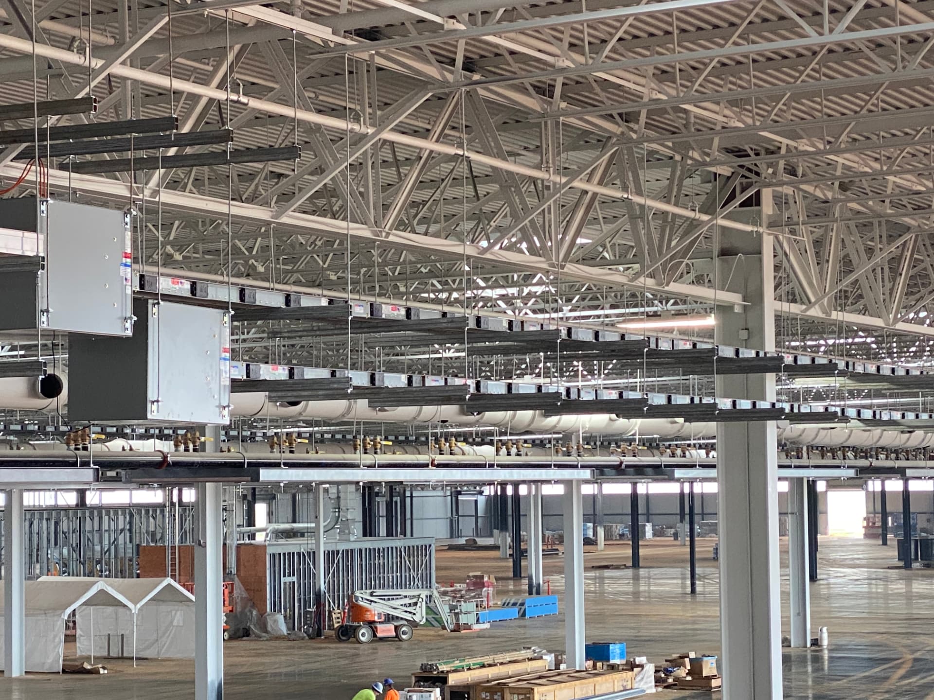 Overhead busway and lighting install in a large plant