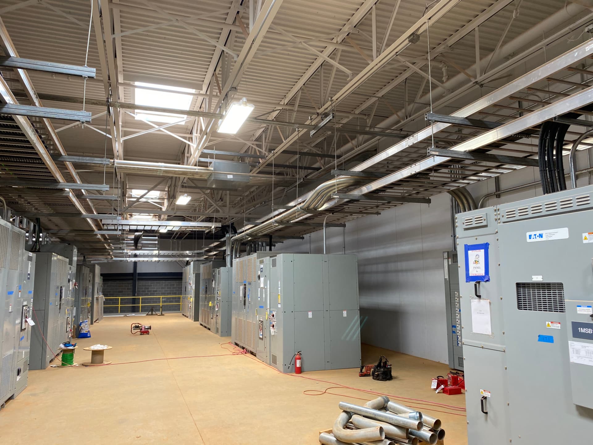 Switchgear lineup and overhead conduit in an electrical room